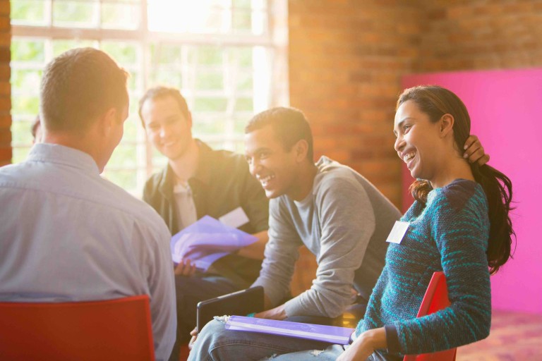 Smiling woman enjoying group therapy session